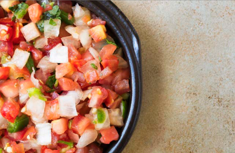 top view shot of a bowl of Pico De Gallo.